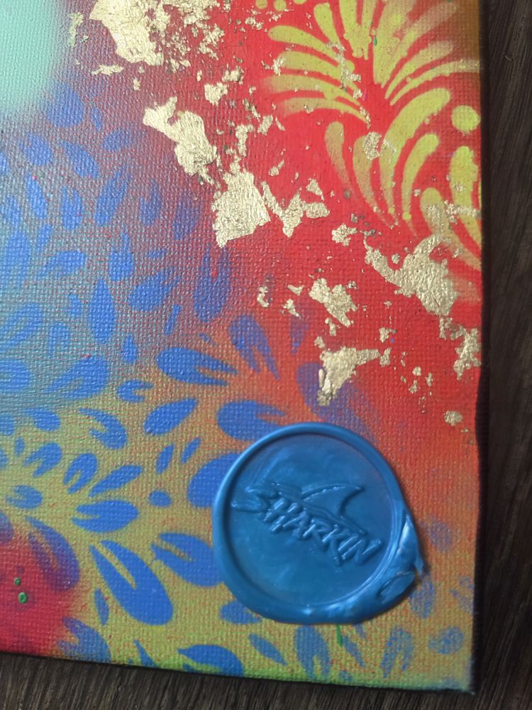 Close-up of gold flake and the blue wax SHARKIN seal on Go Find Something