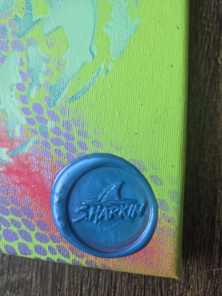 Close-up of the blue wax SHARKIN seal on Shark Garden