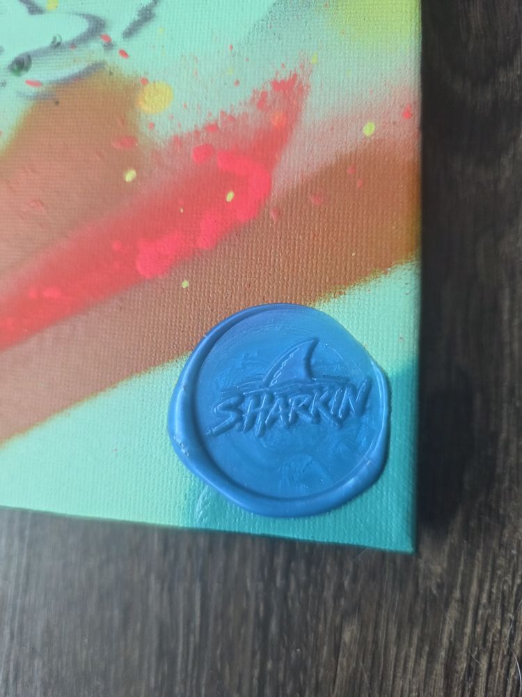 Close-up of the blue wax SHARKIN seal on Reef Frenzy